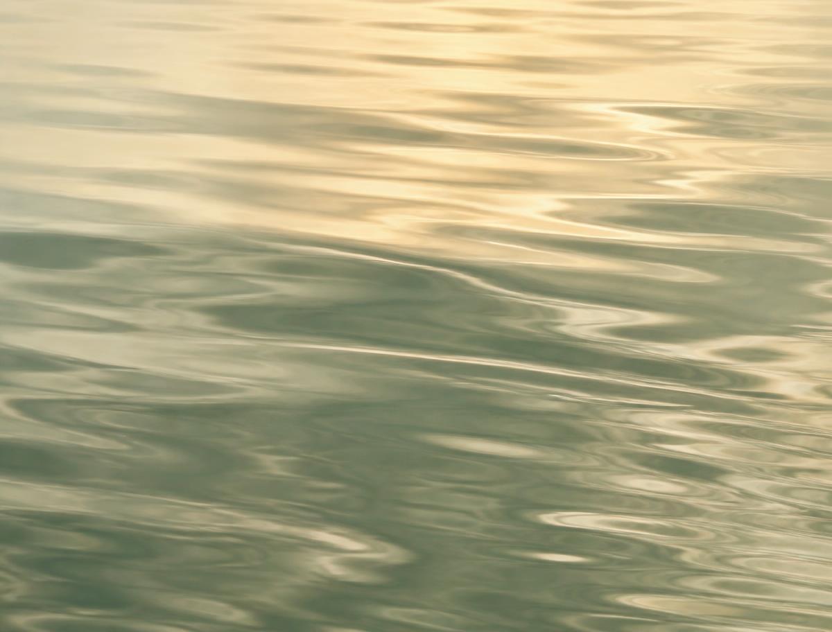 Calm water surface with gentle ripples in soft sage and cream tones